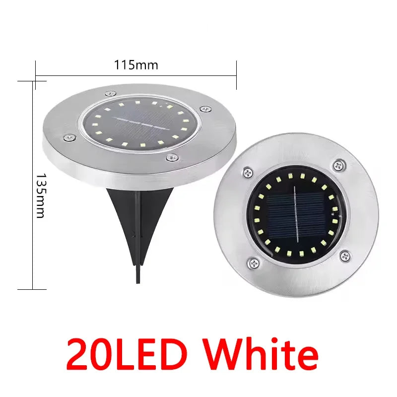Lampe solaire disque enterrée éclairant un jardin la nuit