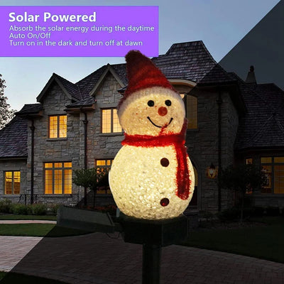 Piquet solaire bonhomme de neige planté dans une pelouse