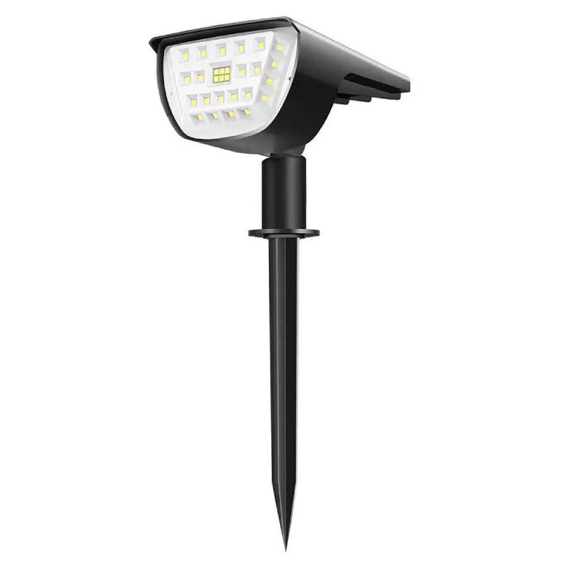Lampe solaire à piquer plantée dans un jardin