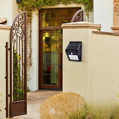 Lampe solaire murale 20 LED installée près d'une porte d'entrée